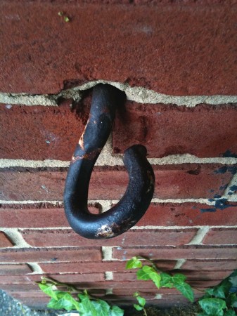 If this was ever used to hook a chain to, it was a long, long, time ago. | No enlargement available. Metal hook-eye.