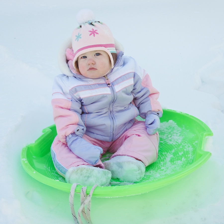 Child in snow saucer.