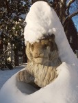 Stone sculpture covered in snow.
