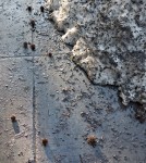 Remnant of snow on sidewalk.