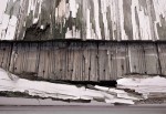 Peeling paint & exposed wood.