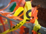 Orange barrier weave and yellow caution tape.