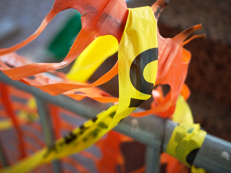 Orange barrier weave and yellow caution tape.