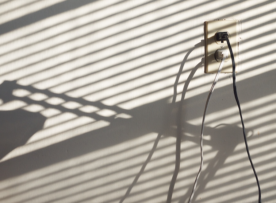 Outlet, wires, shadows.