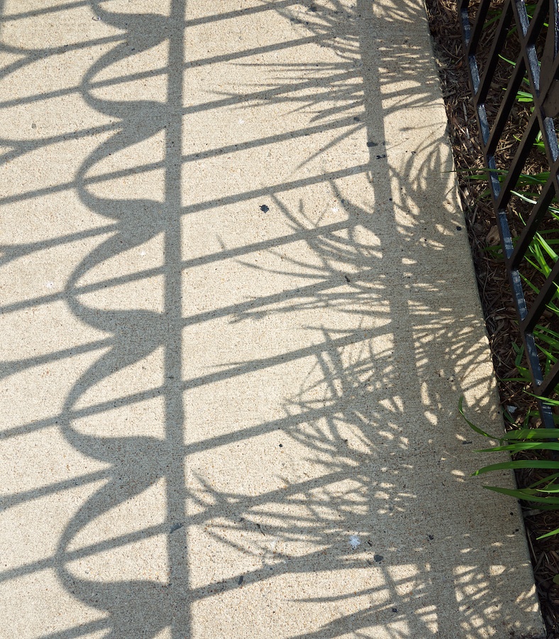 Patterned shadow on pavement.