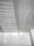 Window shadows on white walls and ceiling.
