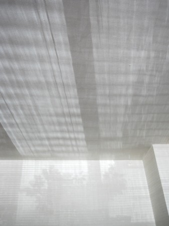 Window shadows on white walls and ceiling.