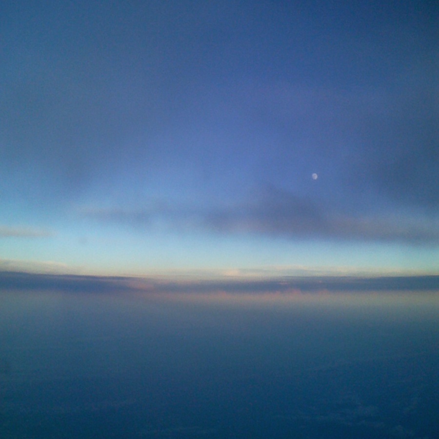 Sunset and Moonrise from an airplane window.
