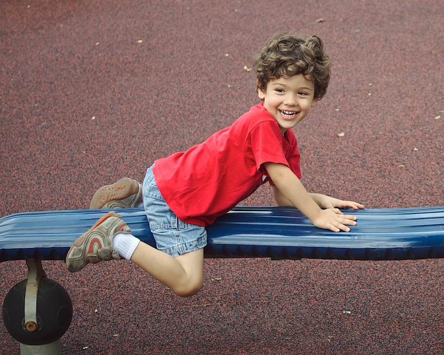 Boy on playground equipment.