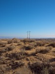Desert, wires, mountains, sky.
