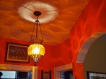 Lamp and cast shadows on walls and ceiling.