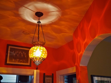 Lamp and cast shadows on walls and ceiling.