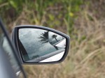 Palm tree reflection in side mirror.