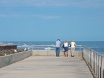 Three people contemplate the ocean, St. Augustine Beach, FL
