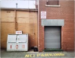 Alley view, ice storage and metal roll-up door.