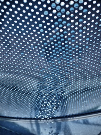 Water droplets through metal grating.