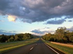 View through the windshield of sunset landscape.