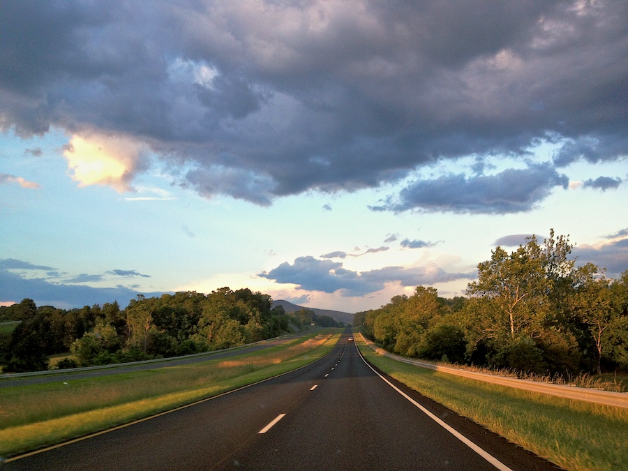 View through the windshield of sunset landscape.