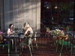Two women dining outdoors.
