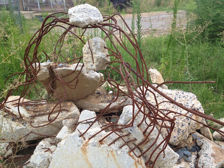 Twisted concrete and metal bars.