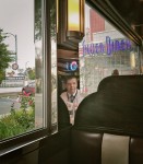 Man reflected in metal surface at diner.