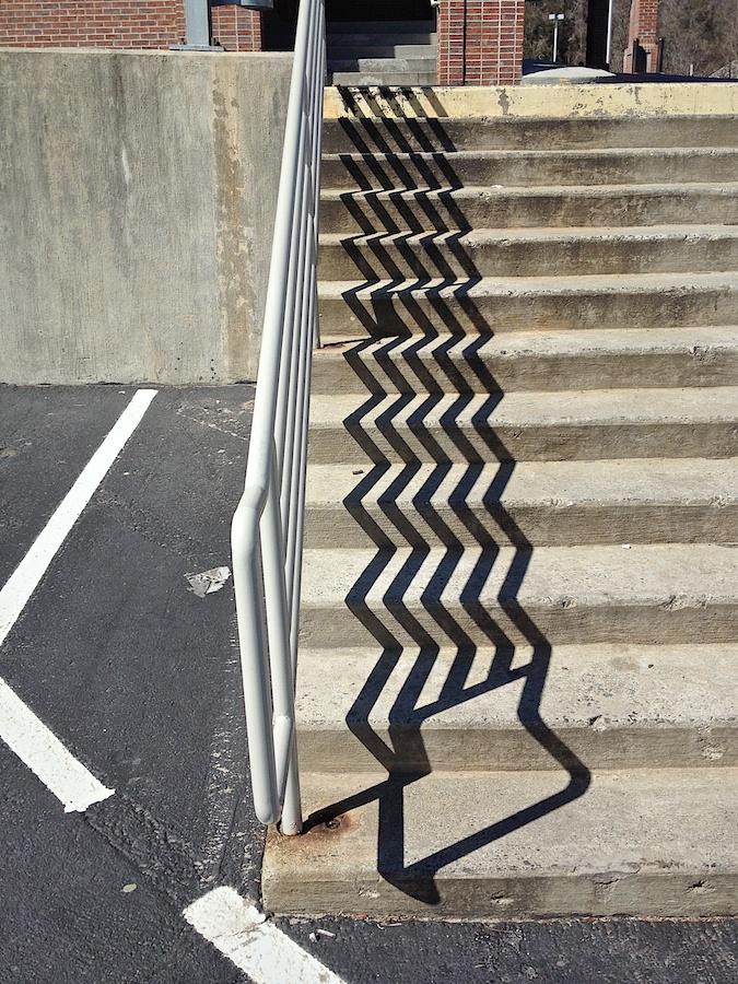 Cement steps with zigzag shadow.